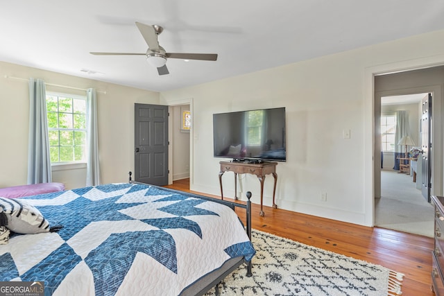 bedroom with wood-type flooring and ceiling fan