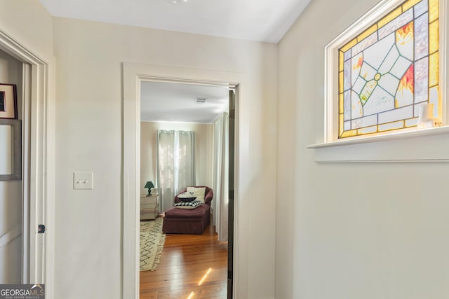 corridor with hardwood / wood-style flooring