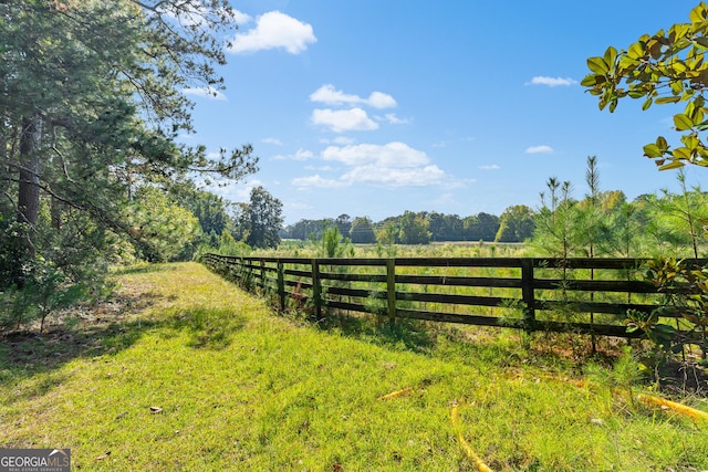 view of gate with a rural view