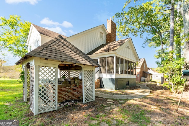 back of property with a sunroom