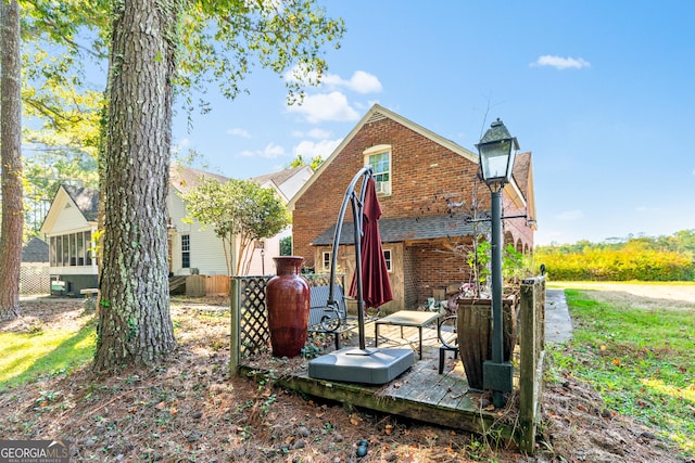 back of property featuring a deck