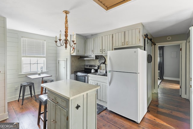 kitchen featuring a center island, dark hardwood / wood-style floors, white refrigerator, stainless steel electric stove, and wooden walls