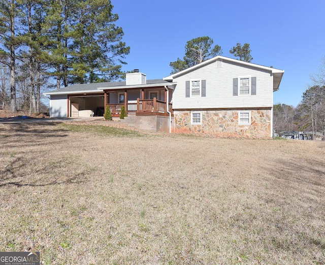 view of front of property with a front yard, stone siding, a chimney, and central AC unit