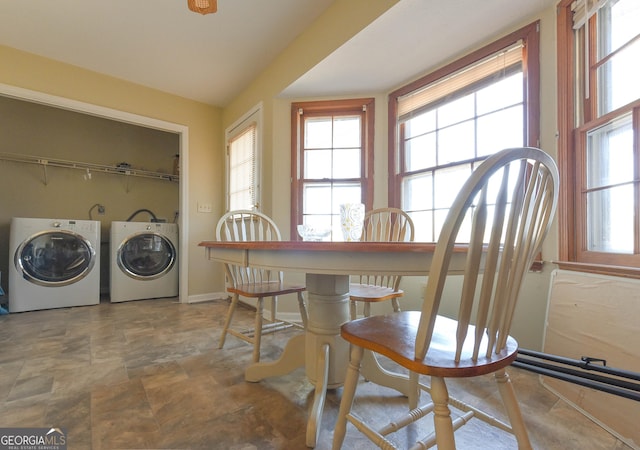 dining space featuring washing machine and dryer and baseboards