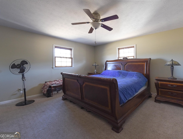 bedroom featuring light colored carpet, multiple windows, and a textured ceiling