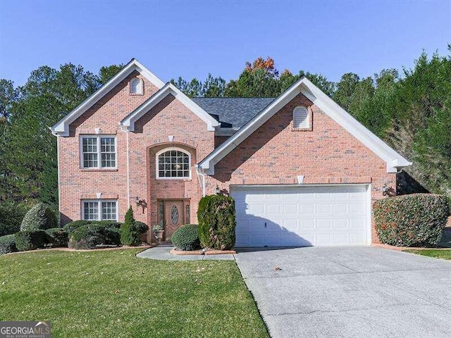 view of property featuring a garage and a front yard