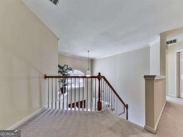 stairs featuring crown molding, carpet floors, and a chandelier