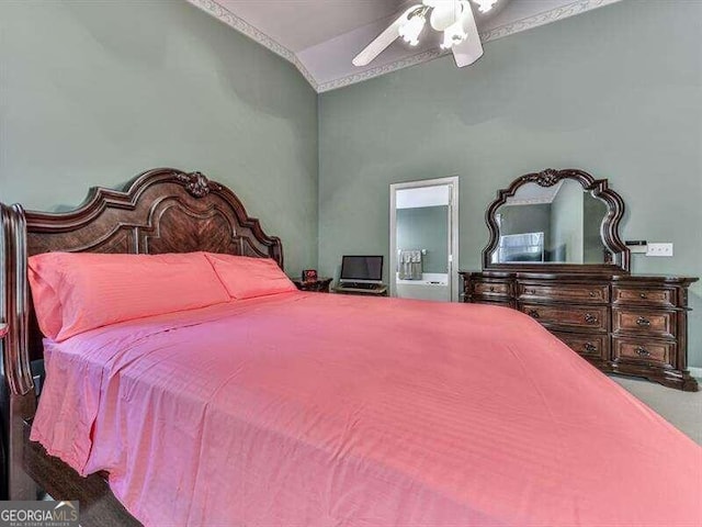 bedroom featuring connected bathroom, vaulted ceiling, and ceiling fan