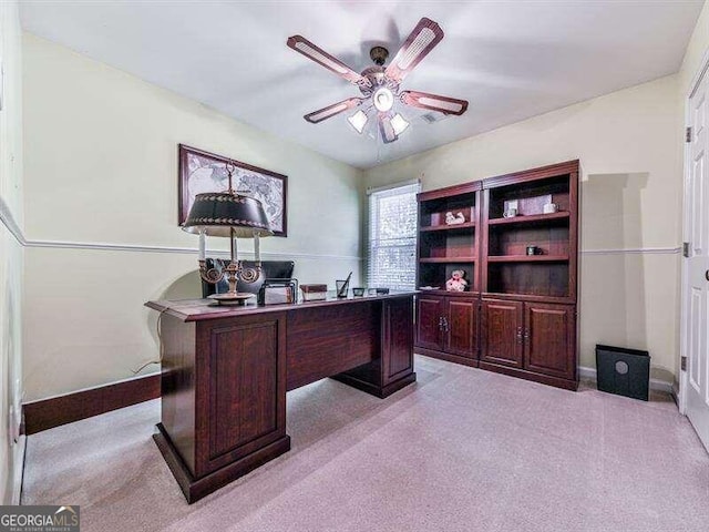 carpeted office featuring ceiling fan