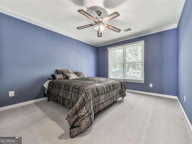 bedroom with ceiling fan, crown molding, and light carpet