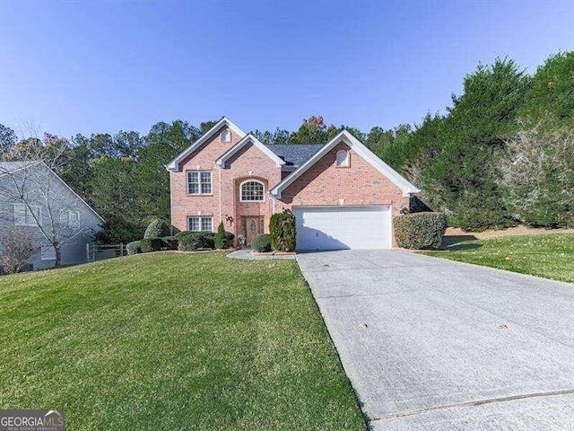 view of property featuring a front lawn and a garage