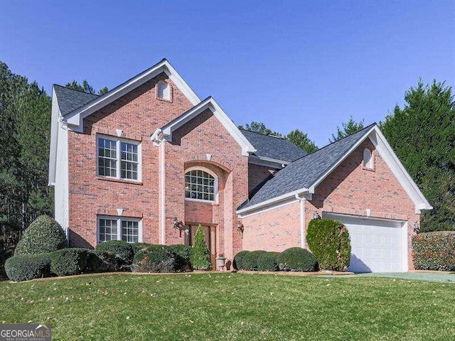 view of property with a garage and a front lawn