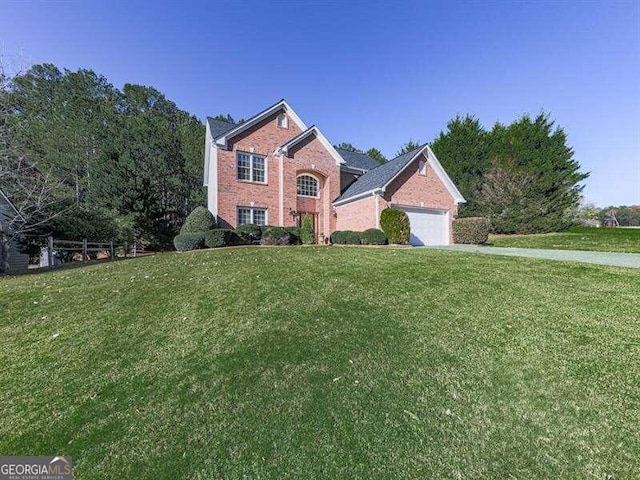 view of property featuring a front yard and a garage