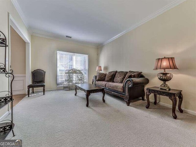 carpeted living room featuring crown molding