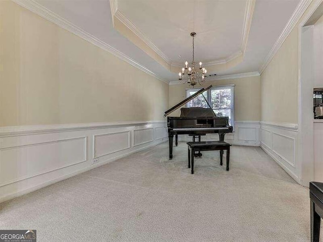 miscellaneous room featuring a tray ceiling, light carpet, crown molding, and an inviting chandelier