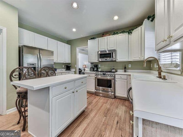 kitchen featuring white cabinets, a center island, and stainless steel appliances