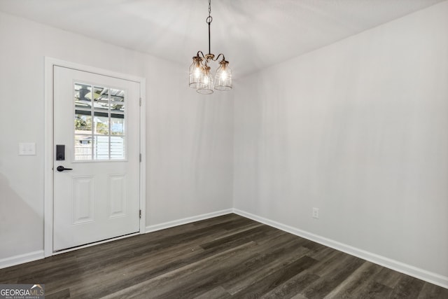 interior space featuring dark wood-type flooring and a notable chandelier