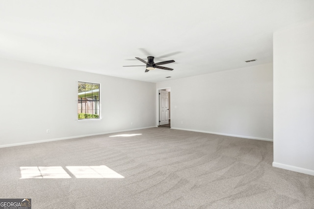 carpeted empty room featuring ceiling fan