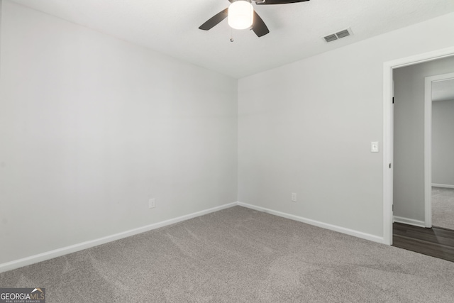 carpeted empty room featuring ceiling fan