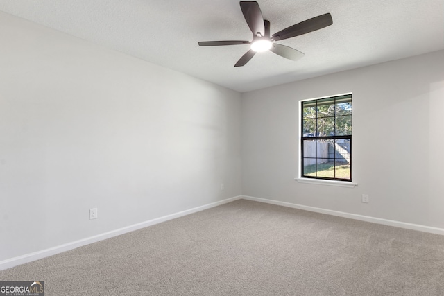 spare room with ceiling fan, carpet, and a textured ceiling