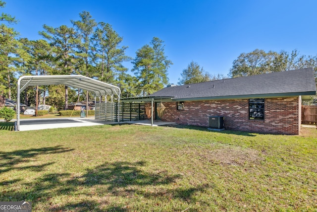 view of yard with central air condition unit and a carport