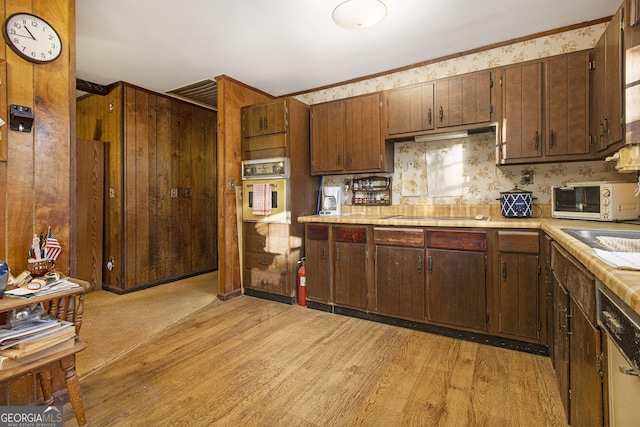 kitchen featuring black electric stovetop, stainless steel oven, dark brown cabinetry, light hardwood / wood-style flooring, and dishwasher