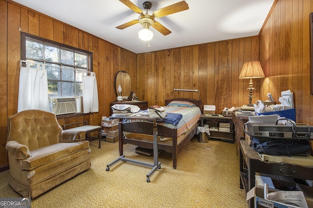 carpeted bedroom with ceiling fan, cooling unit, and wooden walls