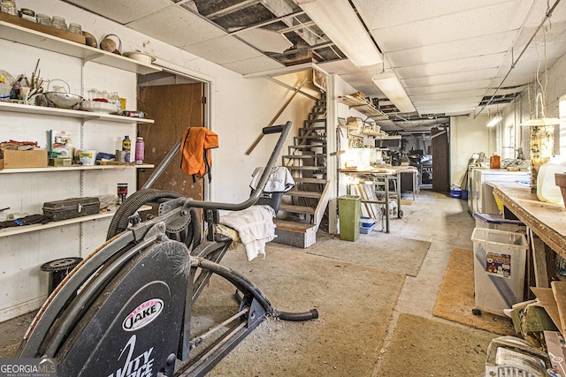 basement with a workshop area and a drop ceiling