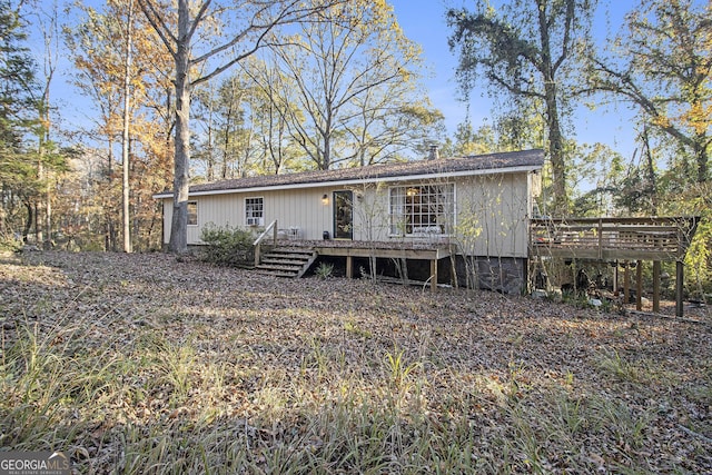 rear view of house featuring a deck