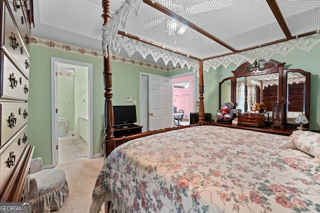 carpeted bedroom featuring ensuite bathroom