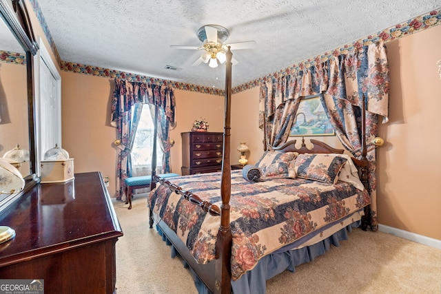 carpeted bedroom featuring ceiling fan, a textured ceiling, and a closet