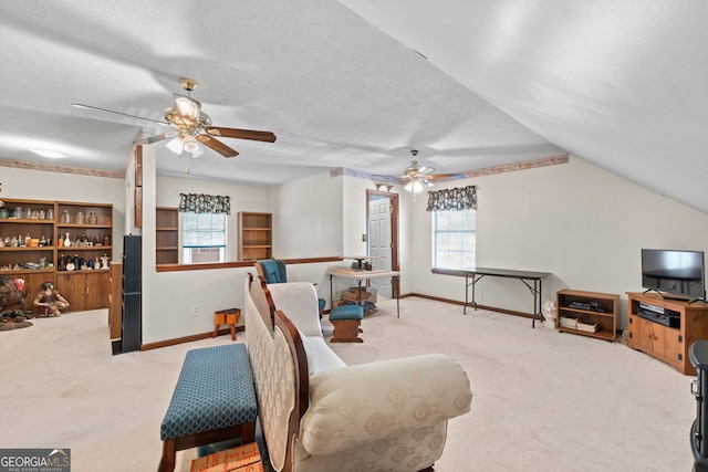 sitting room featuring light carpet, ceiling fan, and a healthy amount of sunlight