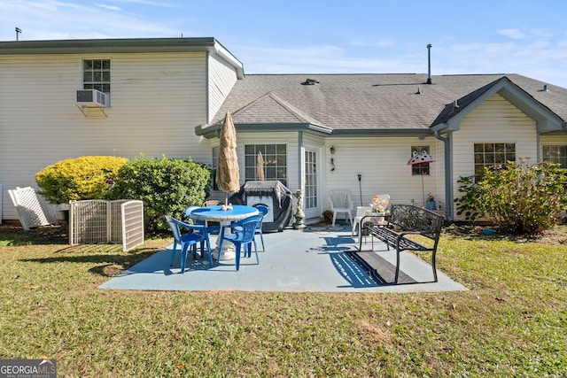 rear view of property with cooling unit, a yard, and a patio