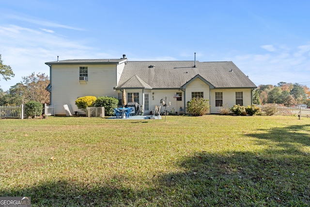 back of house with a patio area and a yard