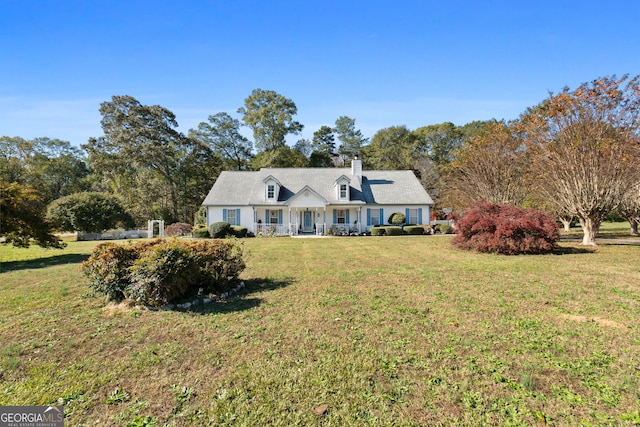 cape cod-style house with a front yard