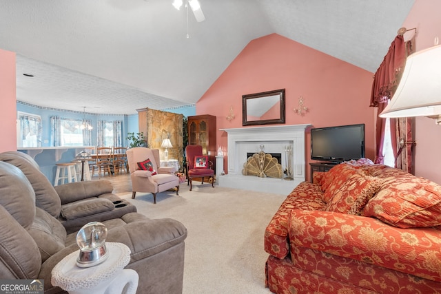 living room with carpet, a textured ceiling, ceiling fan with notable chandelier, and lofted ceiling