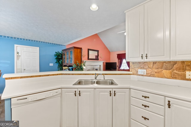 kitchen featuring dishwasher, kitchen peninsula, white cabinets, and sink