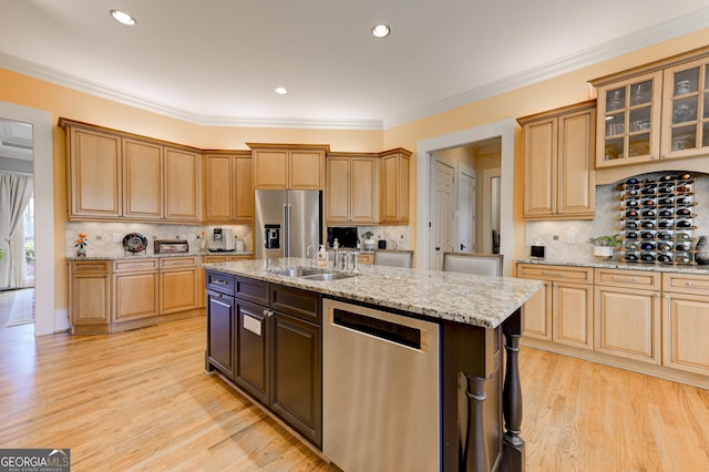 kitchen featuring light stone countertops, appliances with stainless steel finishes, a kitchen island with sink, sink, and light hardwood / wood-style floors