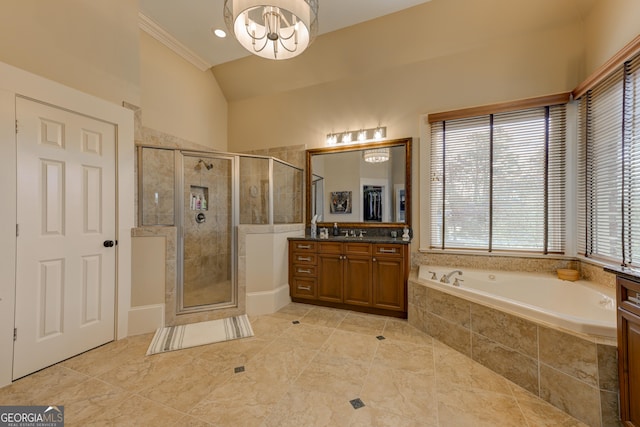 bathroom with an inviting chandelier, tile patterned flooring, separate shower and tub, vaulted ceiling, and vanity