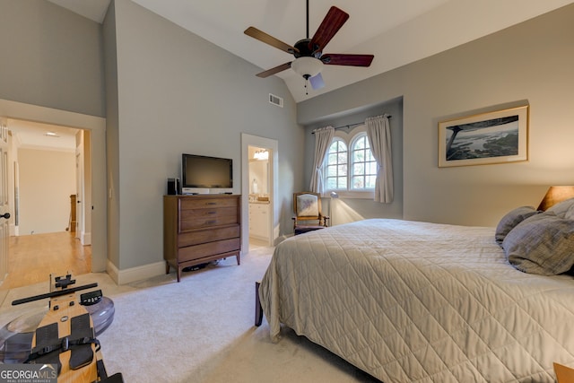 carpeted bedroom with ensuite bath, ceiling fan, and lofted ceiling