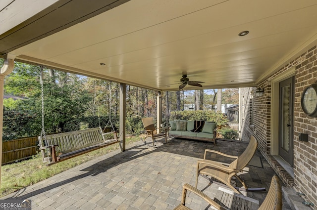 unfurnished sunroom with ceiling fan