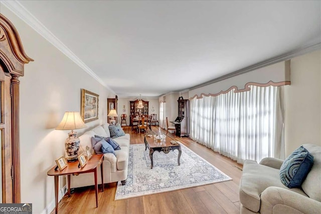 living room featuring ornamental molding and light wood-type flooring