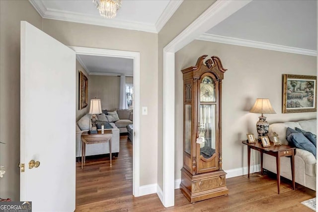 interior space with a chandelier, hardwood / wood-style flooring, and crown molding