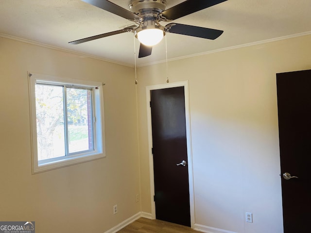 unfurnished bedroom with crown molding, ceiling fan, and hardwood / wood-style flooring