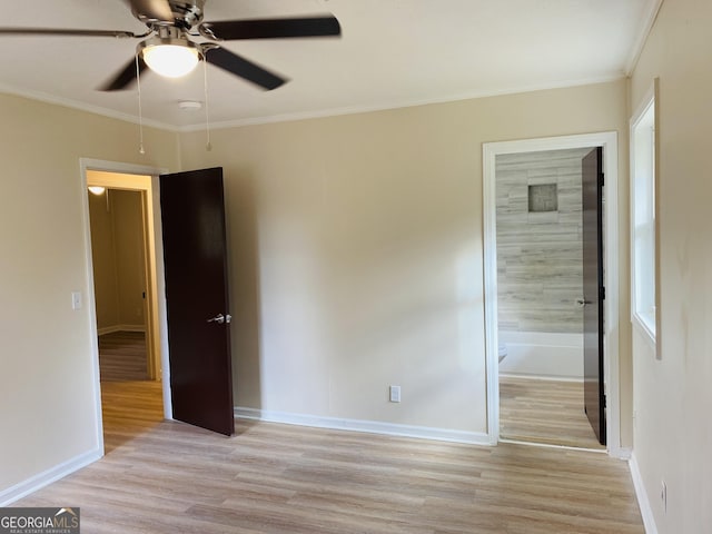 unfurnished bedroom featuring ceiling fan, ensuite bathroom, light wood-type flooring, and ornamental molding