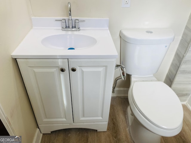 bathroom featuring hardwood / wood-style floors, vanity, and toilet