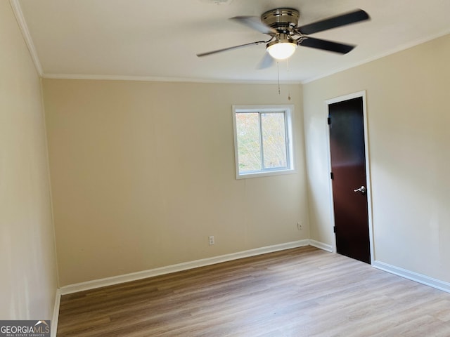 empty room with light hardwood / wood-style flooring, ceiling fan, and ornamental molding