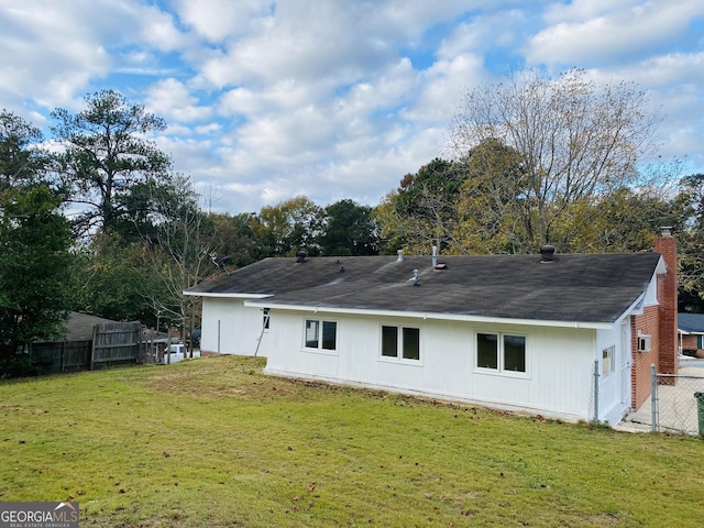 rear view of house with a yard