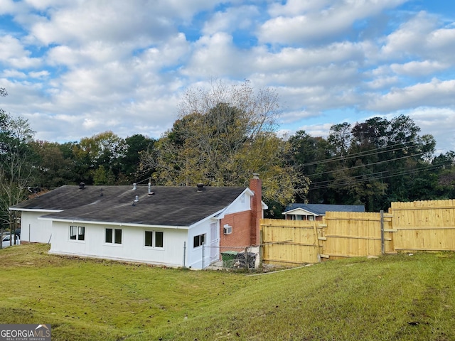 back of property featuring a yard