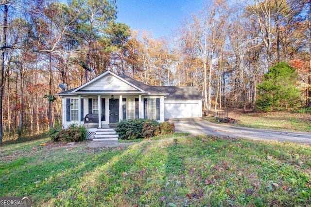 ranch-style home featuring covered porch and a front yard